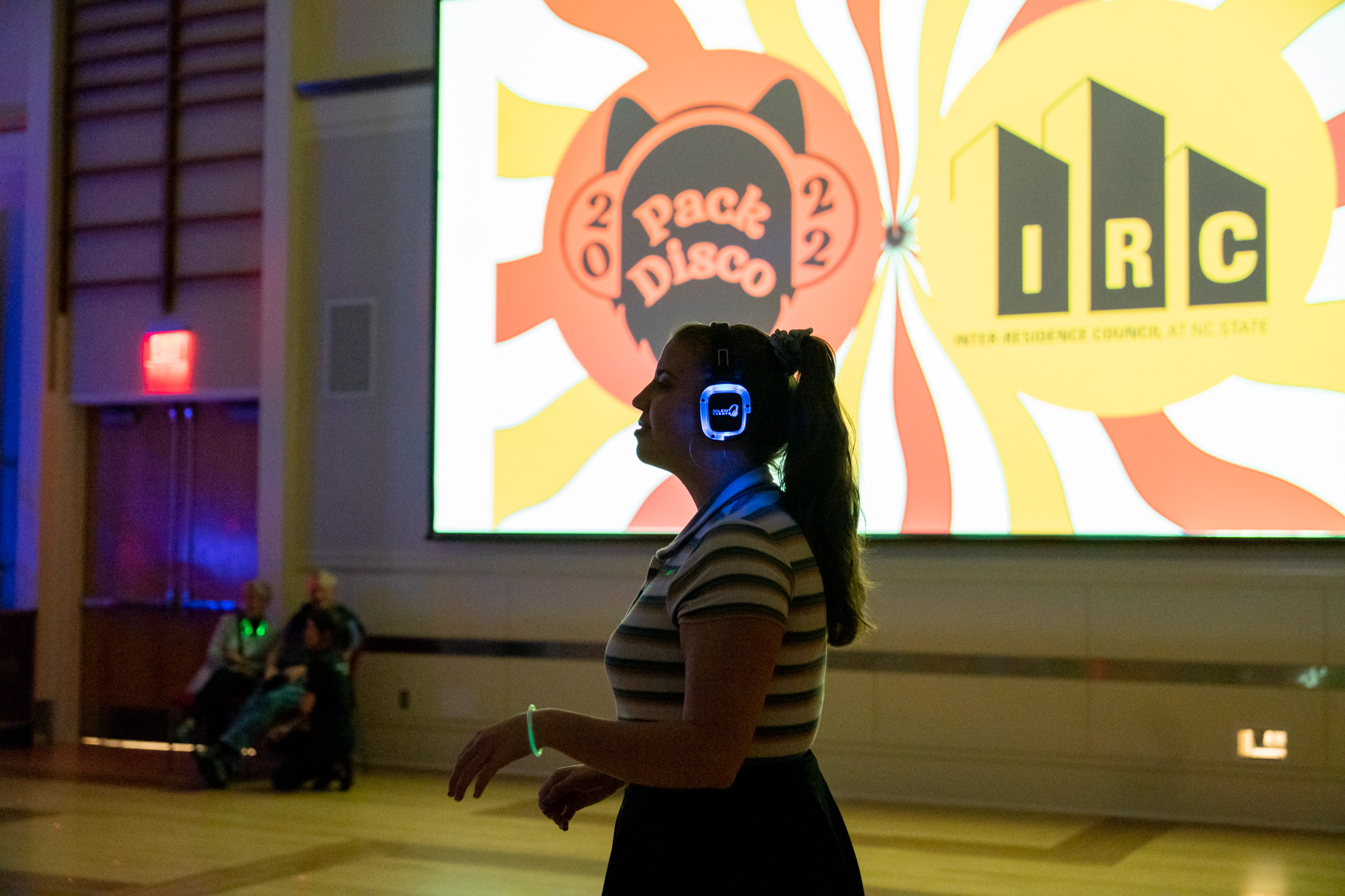 Student listens to music through headphones at IRC's Pack Disco.