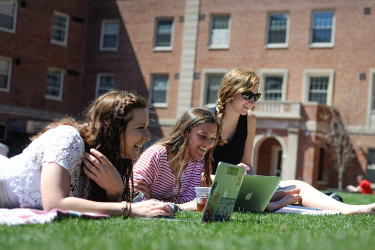 Students study outside of Tucker residence hall.
