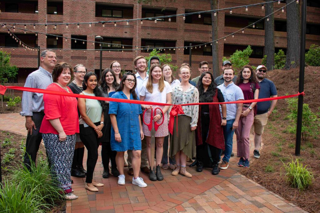 Spring 2023 LAR 506 graduate students stand in front of redesigned outdoor Wood Hall space. 