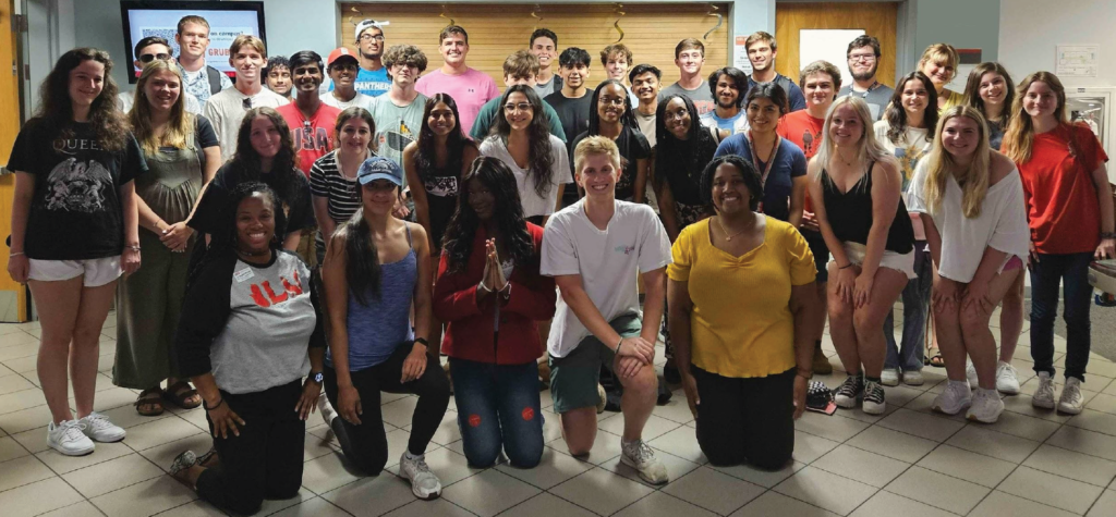 Impact Leadership Villagers and mentors posing in the common area in Bowen Residence Hall. 