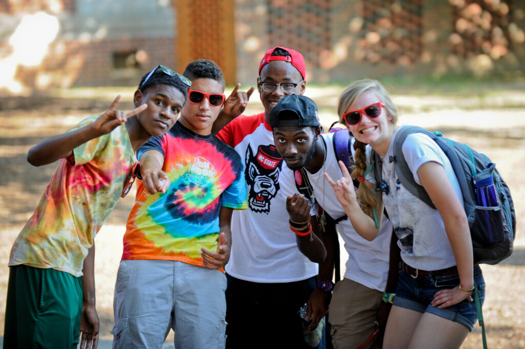 A group of friends pose for the camera as they wait for food at the Chillin' and Grillin' event.